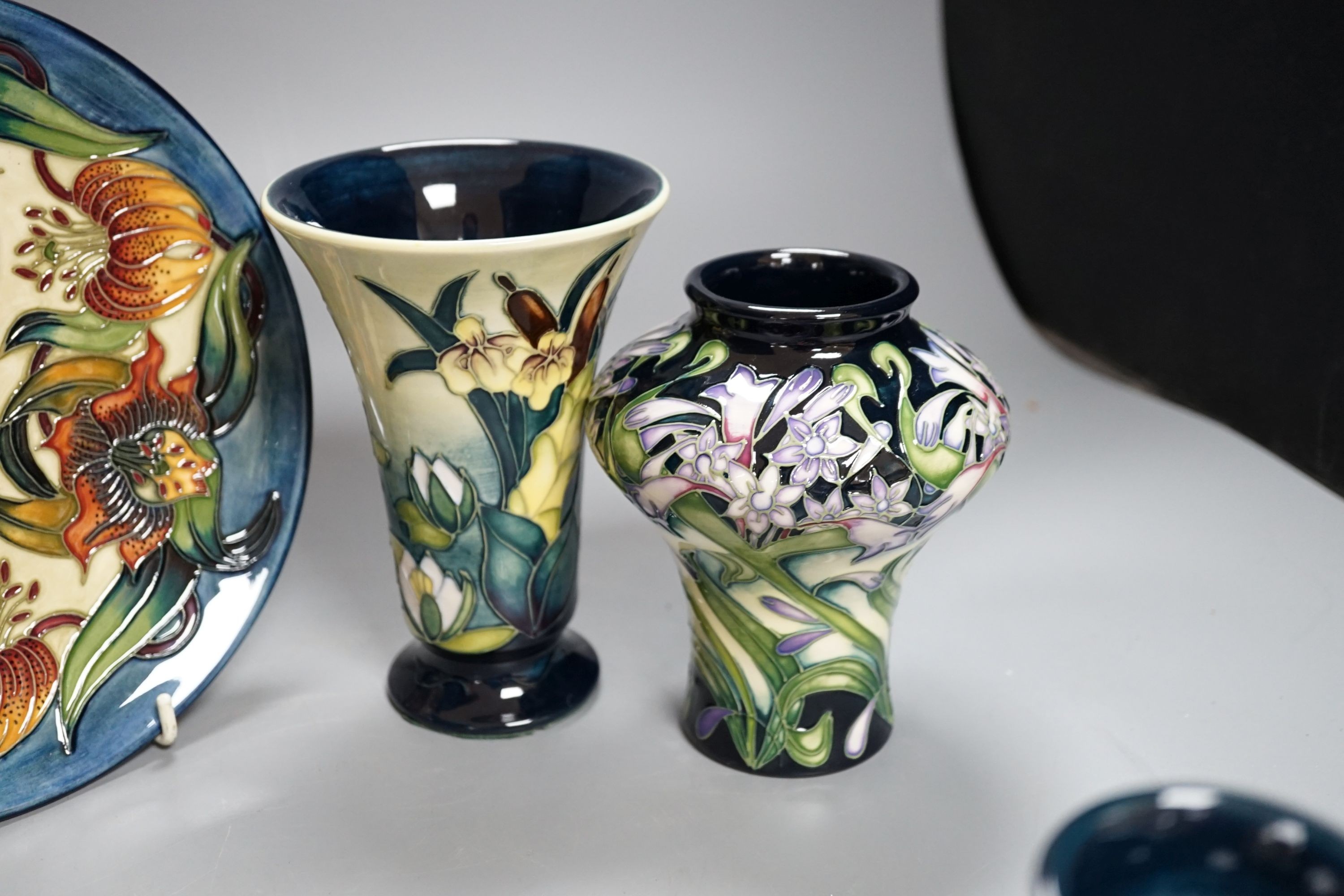 Three modern Moorcroft vases, tallest 15.5 cm and a plate 22 cm